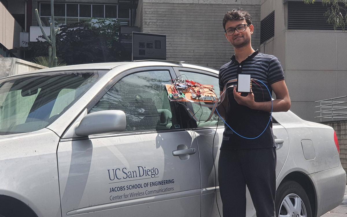 UC San Diego electrical and computer engineering Ph.D. student Ish Jain poses with the new millimeter wave setup that he developed. The setup improves the throughput and reliability of millimeter wave signals.